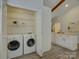 Laundry room featuring appliances and open shelving at 5601 Londonderry Rd, Charlotte, NC 28210