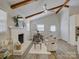 Cozy living room with vaulted ceilings, brick fireplace, and lots of natural light at 5601 Londonderry Rd, Charlotte, NC 28210