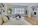 Bright and open living room with hardwood floors, modern fireplace, and large windows at 5601 Londonderry Rd, Charlotte, NC 28210