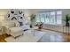 Bright living room with hardwood floors, modern decor, and a large bay window at 5601 Londonderry Rd, Charlotte, NC 28210