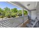 Outdoor balcony with seating and a view of the surrounding neighborhood and mature trees at 6053 Treetop Ct, Charlotte, NC 28212