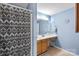 Cozy bathroom featuring a shower with patterned curtain and a single sink vanity at 6053 Treetop Ct, Charlotte, NC 28212