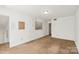 Bedroom with carpet, an adjoining room, and a window at 6053 Treetop Ct, Charlotte, NC 28212