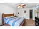 Bedroom featuring natural light, striped comforter, wooden furniture, and access to the bathroom at 6053 Treetop Ct, Charlotte, NC 28212