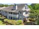 Attractive gray two-story home with a covered balcony and lush, mature landscaping at 6053 Treetop Ct, Charlotte, NC 28212