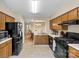 The kitchen has wooden cabinets, modern appliances, and a view into the dining room at 6053 Treetop Ct, Charlotte, NC 28212
