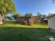 Expansive backyard featuring well-maintained lawn and inviting back deck at 609 E Maine Ave, Bessemer City, NC 28016