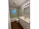This bathroom has a tub, toilet, sink, vanity, and updated lighting at 609 E Maine Ave, Bessemer City, NC 28016