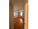 A bright room with wood floors and two windows at 609 E Maine Ave, Bessemer City, NC 28016