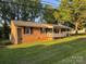 Cozy brick home with a front porch and well-kept lawn on a sunny day at 609 E Maine Ave, Bessemer City, NC 28016