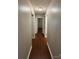 Hallway with wood floors, neutral walls, and multiple doorways at 609 E Maine Ave, Bessemer City, NC 28016
