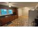 Open kitchen area with wood cabinets and vinyl flooring, providing a practical space at 609 E Maine Ave, Bessemer City, NC 28016