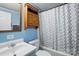 A full bathroom with blue walls features a shower-tub combo and a white sink at 621 Harper Davis Rd, Lake Wylie, SC 29710