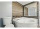 This is the bathroom which features wood paneling on the wall and a relaxing jacuzzi tub at 621 Harper Davis Rd, Lake Wylie, SC 29710
