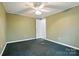 This bedroom has green walls and floors, ceiling fan, and a door way to other areas of the house at 621 Harper Davis Rd, Lake Wylie, SC 29710