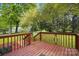 A wood deck overlooks the property's yard, surrounded by lush trees at 621 Harper Davis Rd, Lake Wylie, SC 29710