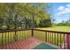 An elevated wood deck looks out on a beautiful green yard with tall trees at 621 Harper Davis Rd, Lake Wylie, SC 29710