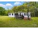 Charming single-story home with a front deck and lush green lawn at 621 Harper Davis Rd, Lake Wylie, SC 29710