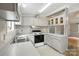 The kitchen has ample storage space with white cabinets, countertops and a stainless steel sink and stove at 621 Harper Davis Rd, Lake Wylie, SC 29710