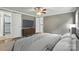 The main bedroom features a ceiling fan, hard wood floors, a TV and a door to the connected bathroom at 621 Harper Davis Rd, Lake Wylie, SC 29710