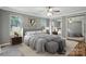 This is the main bedroom, featuring a large bed, a mirrored closet, and two windows with a lovely yard view at 621 Harper Davis Rd, Lake Wylie, SC 29710