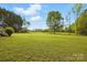 An expansive green yard features a large tree and a clear blue sky at 621 Harper Davis Rd, Lake Wylie, SC 29710