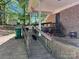 The back porch has a grill, a seating area, and a ramp, for relaxing or entertaining guests at 6212 Sunset Cir, Charlotte, NC 28216