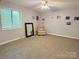 Spacious bedroom with plush carpeting and large window, offering a serene retreat at 6212 Sunset Cir, Charlotte, NC 28216