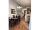 Inviting dining area featuring wood floors, a pendant light, and stylish furnishings at 6212 Sunset Cir, Charlotte, NC 28216
