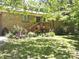 Charming brick home with wooden deck, complemented by a lush landscaped front yard at 6212 Sunset Cir, Charlotte, NC 28216