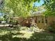 Landscaped home with a covered back porch, a wood deck, and large windows at 6212 Sunset Cir, Charlotte, NC 28216