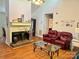 Inviting living room with vaulted ceiling, brick fireplace, and comfortable seating at 6212 Sunset Cir, Charlotte, NC 28216