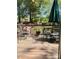 Cozy outdoor deck provides ample seating with an umbrella and potted plants, perfect for entertaining at 6212 Sunset Cir, Charlotte, NC 28216