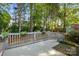 Wooden backyard deck with gray railings surrounded by trees and flower boxes provides a cozy outdoor space at 6307 Old Corral St, Charlotte, NC 28277