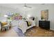 Comfortable bedroom with bright window, ceiling fan, and modern decor at 6307 Old Corral St, Charlotte, NC 28277