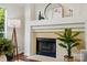A cozy fireplace with decor and a large plant at 6307 Old Corral St, Charlotte, NC 28277