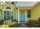 Inviting front entrance features a bright blue door, well-manicured landscaping, and large windows for natural light at 6307 Old Corral St, Charlotte, NC 28277