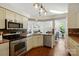 Well-lit kitchen boasts stainless steel appliances and ample counter space at 6307 Old Corral St, Charlotte, NC 28277