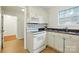 White kitchen features modern appliances, granite countertops and ample lighting at 6307 Old Corral St, Charlotte, NC 28277