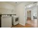 Convenient laundry room with modern washer and dryer units and ample storage space at 6307 Old Corral St, Charlotte, NC 28277