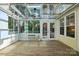 Bright sunroom with skylights, wood floors, and access to the outdoor deck offers ample natural light and extra living space at 6307 Old Corral St, Charlotte, NC 28277