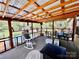 Covered back porch with wood beams and view of the spacious backyard at 6401 Alley Rd, Catawba, NC 28609