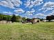 View of the backyard with a deck, above ground pool, shed and green lawn at 6401 Alley Rd, Catawba, NC 28609