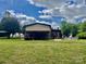 Extensive property featuring a spacious backyard with lawn equipment parked under a covered structure and an above-ground pool at 6401 Alley Rd, Catawba, NC 28609