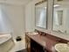 The bathroom has a light pink vanity, white walls, two mirrors, and a tub at 6401 Alley Rd, Catawba, NC 28609