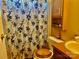 The bathroom features a neutral floral shower curtain, a wood vanity, and a wood toilet seat at 6401 Alley Rd, Catawba, NC 28609