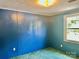 This bedroom features a large window, blue walls, and textured green carpet at 6401 Alley Rd, Catawba, NC 28609