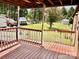 Outdoor wooden deck overlooking a spacious, green backyard with mature trees at 6401 Alley Rd, Catawba, NC 28609