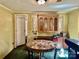 The dining room has neutral wall paint, green carpet, wood blinds, and a decorative cabinet at 6401 Alley Rd, Catawba, NC 28609