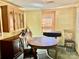 This dining room has neutral wall paint, green carpet, wood blinds, and a decorative cabinet at 6401 Alley Rd, Catawba, NC 28609